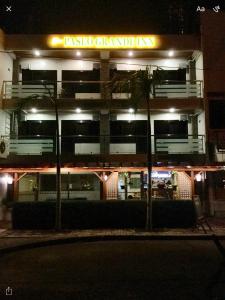 a building with a sign that reads tasso catalystinary at night at Blue Paseo Grande Inn in Naga