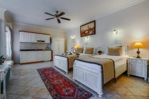 a bedroom with two beds and a kitchen at La Paloma Hotel in Antalya