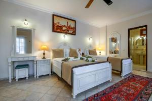 a large bedroom with two beds and a fireplace at La Paloma Hotel in Antalya