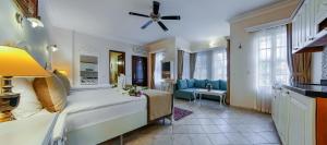 a bedroom with a bed and a living room at La Paloma Hotel in Antalya