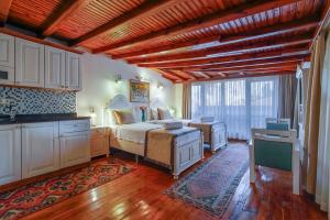 a large bedroom with a bed and a kitchen at La Paloma Hotel in Antalya