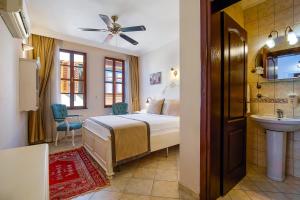a bedroom with a bed and a sink and a bathroom at La Paloma Hotel in Antalya