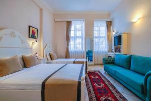 a hotel room with a bed and a couch at La Paloma Hotel in Antalya