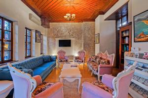 a living room with a blue couch and chairs at La Paloma Hotel in Antalya