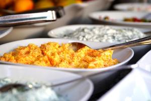 a bowl of food on a table with a spoon at La Paloma Hotel in Antalya