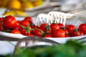 a bunch of tomatoes in a bowl on a table at La Paloma Hotel in Antalya
