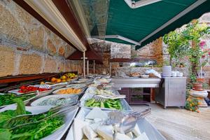 a buffet line with many different types of fruits and vegetables at La Paloma Hotel in Antalya