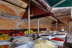 a buffet line with bowls of different types of food at La Paloma Hotel in Antalya