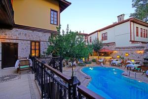 a balcony with a swimming pool next to a building at La Paloma Hotel in Antalya