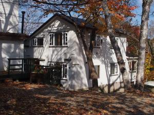 a white house with trees in front of it at Hon Kan in Otaru