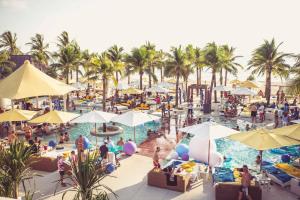a group of people at a resort swimming pool at T House in Bang Tao Beach