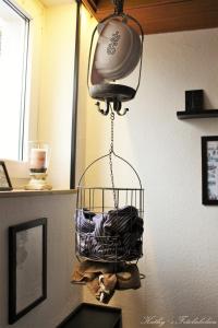 a basket hanging from a wall with a fan at Hotel Vogt in Bad Driburg