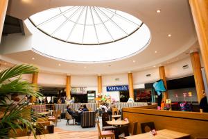 a restaurant with a domed ceiling and people sitting at tables at Days Inn Stafford in Stafford