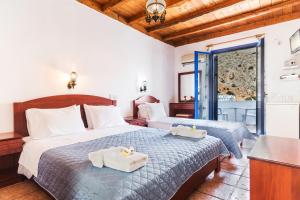 Postel nebo postele na pokoji v ubytování Daskalogiannis Hotel