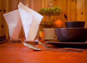 a table with plates and utensils on a table with napkins at B&B Principe all'Arena in Verona