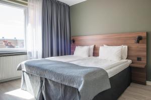 Postel nebo postele na pokoji v ubytování Quality Hotel Grand Kristianstad