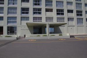 un aparcamiento vacío frente a un edificio en Bloubergviews, en Bloubergstrand