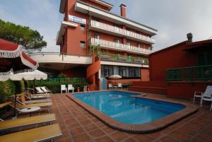 a hotel with a swimming pool in front of a building at Hotel La Querceta in Montecatini Terme