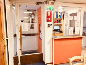 a door leading into a room with a desk at Matkakoti Patria Hostel - single & double rooms in Lahti