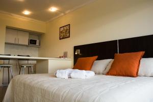 a bedroom with a large bed with towels on it at Rio Manso Apartamentos in Victoria