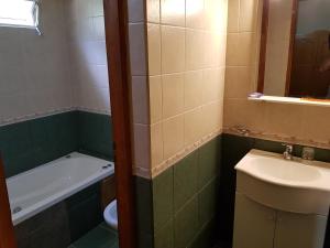 a bathroom with a sink and a toilet and a bath tub at Complejo Don Osvaldo in Sierra de la Ventana +17 photos