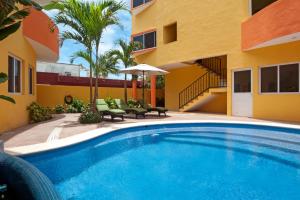 a swimming pool in the backyard of a house at Kaam Accommodations in Puerto Morelos