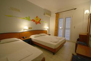 Postel nebo postele na pokoji v ubytování Metaxa Hotel