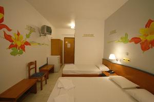 Postel nebo postele na pokoji v ubytování Metaxa Hotel
