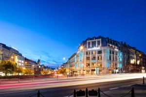 a city street at night with buildings and street lights at Occidental Praha Wilson in Prague