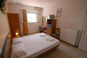 Postel nebo postele na pokoji v ubytování Metaxa Hotel