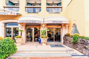 a large building with a balcony and a walkway at Aragona Palace Hotel & Spa in Ischia