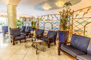 a living room filled with couches and chairs at Aragona Palace Hotel & Spa in Ischia
