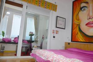 A bed or beds in a room at EcoHouse & BioVeg Café