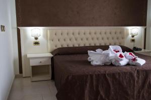 Postel nebo postele na pokoji v ubytování Hotel Madonna Delle Grazie