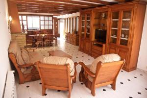 a living room with wooden furniture and a dining room at Casa Pintor in Sant Sadurní dʼAnoia