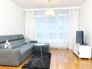 a living room with a couch and a tv at Apartamenty Residence Aparthotel in Szczecin +39 photos