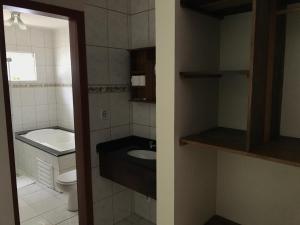 a small bathroom with a sink and a toilet at Pousada Vila Verde in Porto Belo