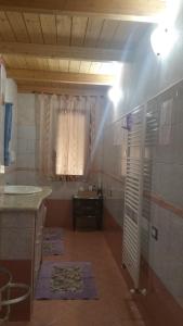 a room with a bathroom with a sink and a window at SA SPENDULA B&B in Villacidro