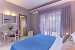 Posteľ alebo postele v izbe v ubytovaní Nymphes Luxury Apartments