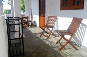 a group of chairs sitting on a porch at Villa Mihindi in Hikkaduwa