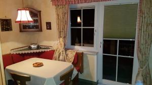 a dining room with a table and a window at Haus Rochard in Kienzen