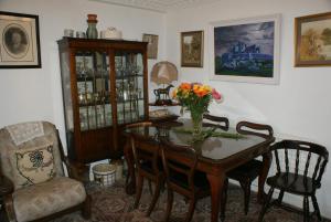 a dining room with a table with flowers on it at Rockville House B&B in Cashel
