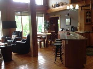 a kitchen and living room with a table and chairs at Strong Timbers BnB in Kingsclear