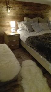 a bedroom with a bed and two white rugs at Kitzdesign in Kirchberg in Kirchberg in Tirol
