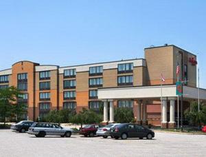 a large building with cars parked in a parking lot at Fairbridge Hotel Cleveland East in Wickliffe