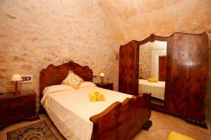 a bedroom with a bed and a large mirror at Quality Villa Es Molí in Porreres