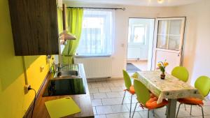 una cocina con mesa y sillas y una cocina de color amarillo en FeWo Albrecht in Metschow, en Borrentin