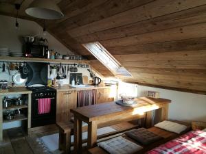 a kitchen with a wooden table and a stove at Apartmany Bublava 817 in Bublava