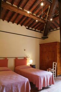 PiaggioriにあるLa Chiusa di Nanniの木製の天井のベッドルーム1室(ベッド2台付)