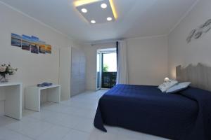 a bedroom with a blue bed in a white room at Casa Irene in Piano di Sorrento